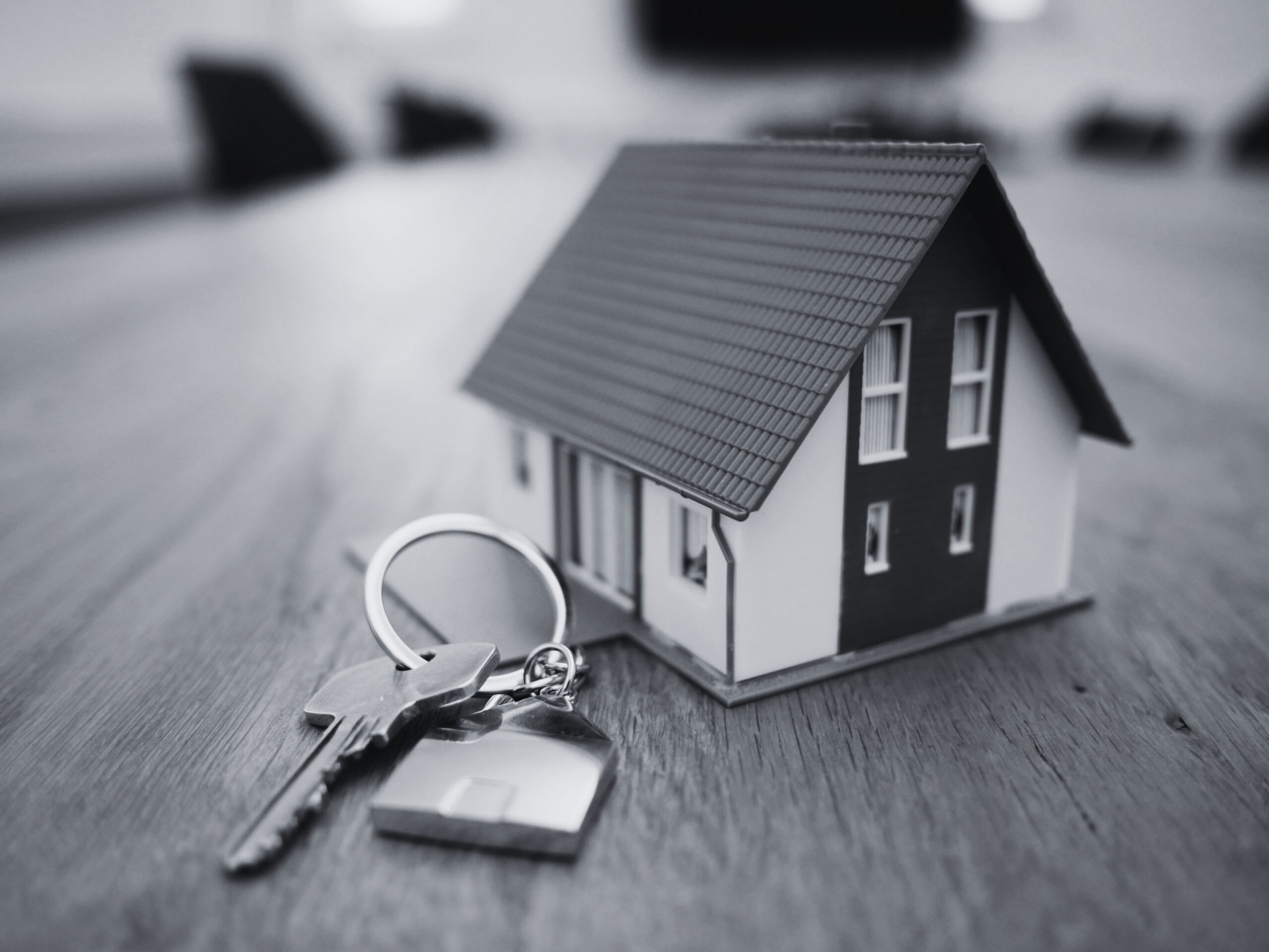 House keys and model showing real estate ownership