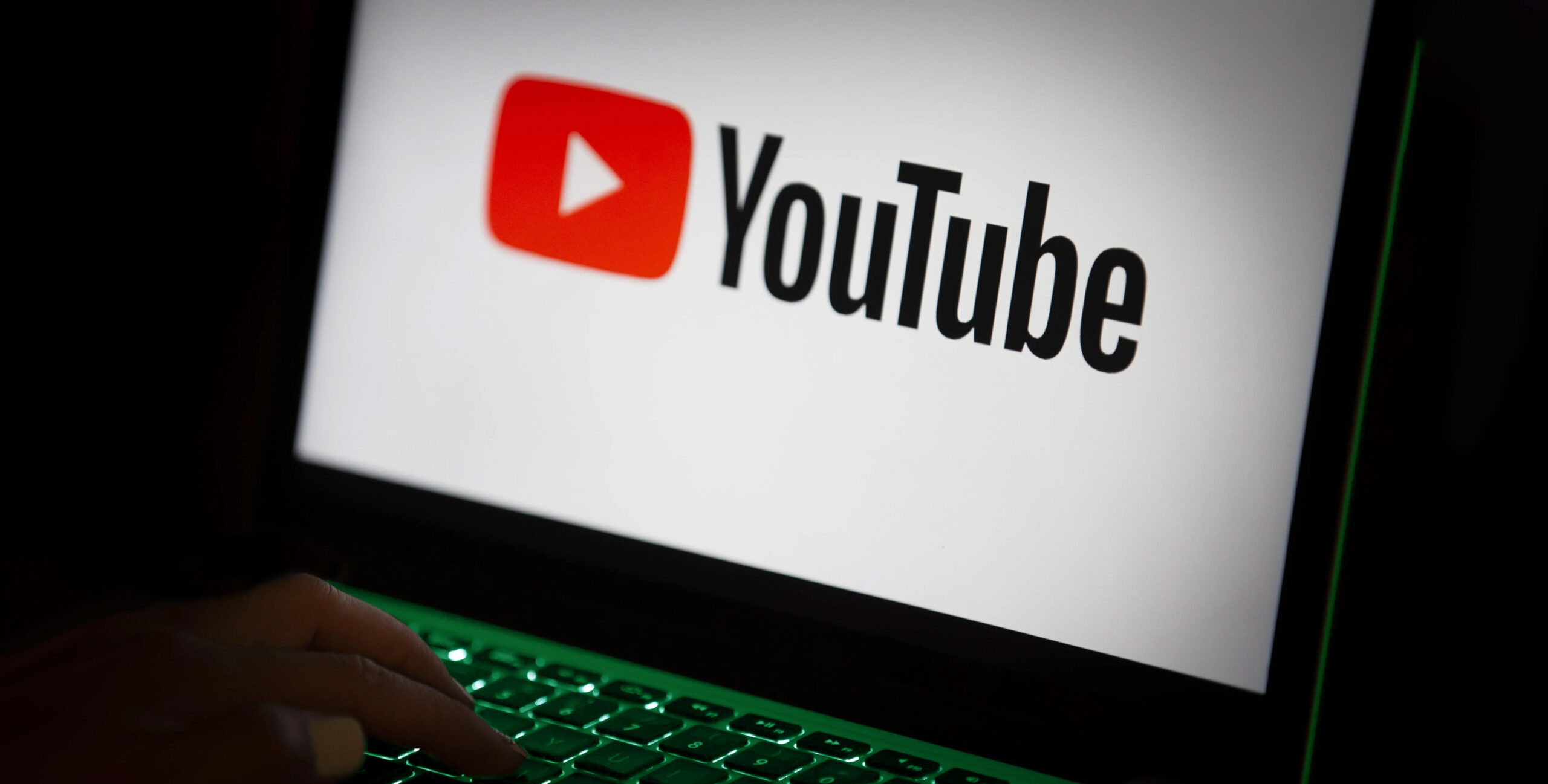 YouTube logo on laptop keyboard, video marketing for real estate brands