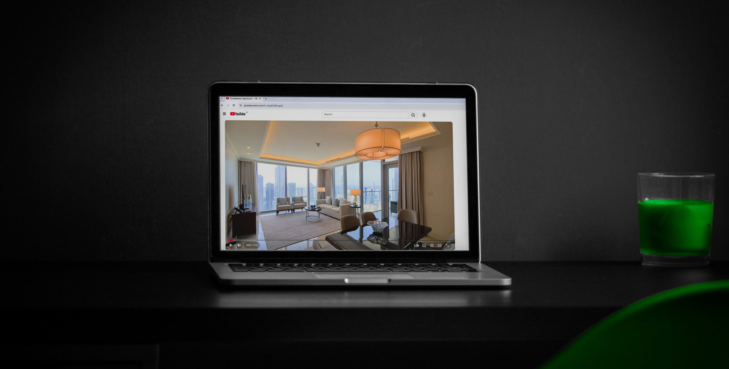Laptop playing a YouTube property tour, real estate video marketing