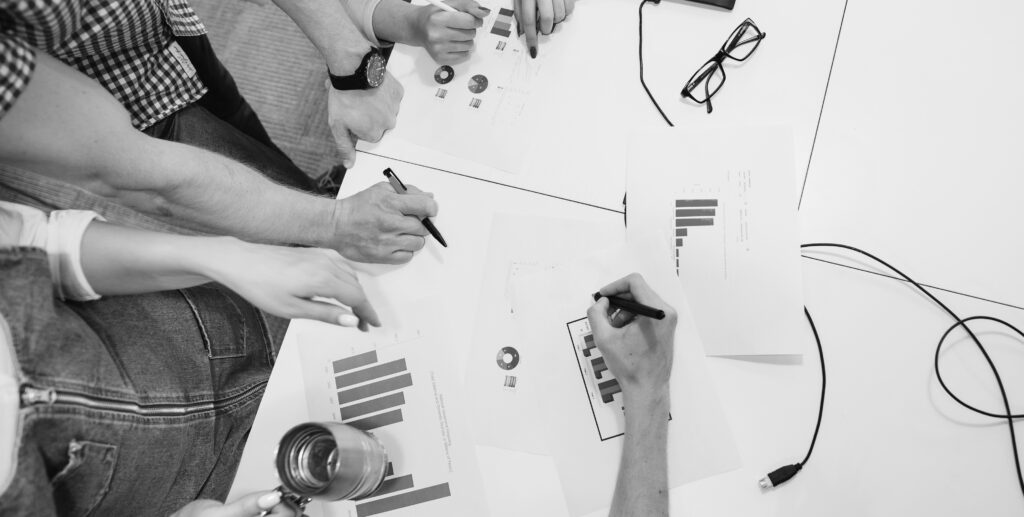 Team analyzing performance reports, real estate marketing data analysis