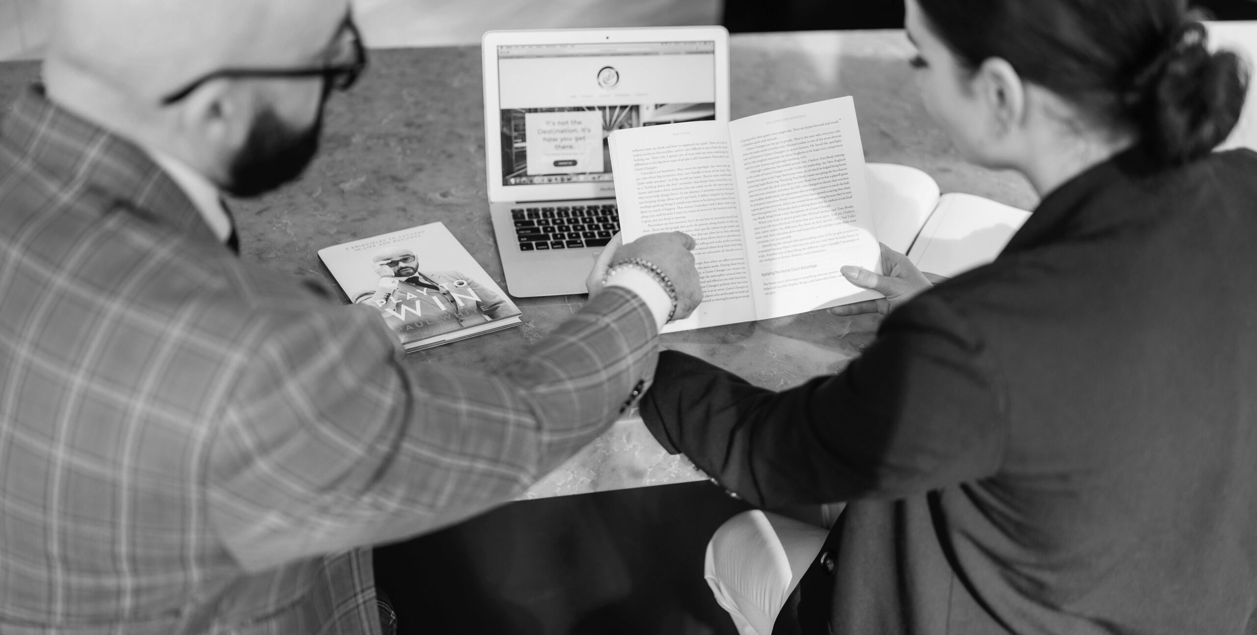 Two professionals reviewing a case study, real estate marketing review