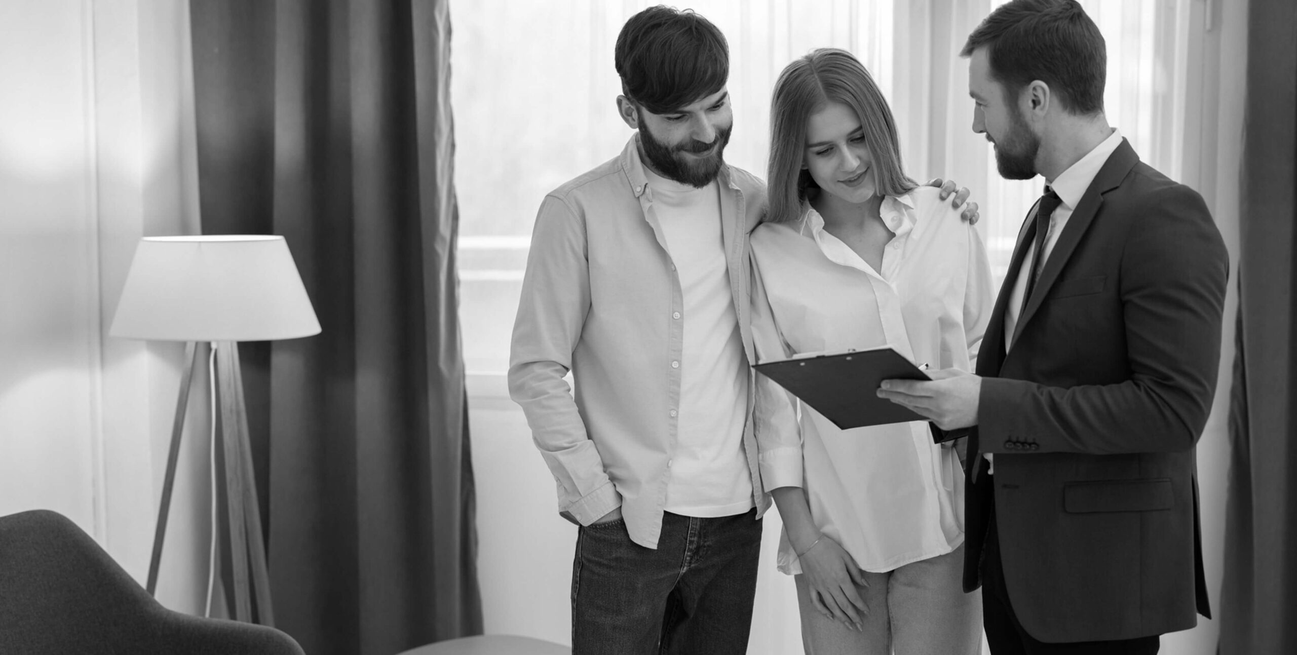 Real estate agent showing property details to a couple