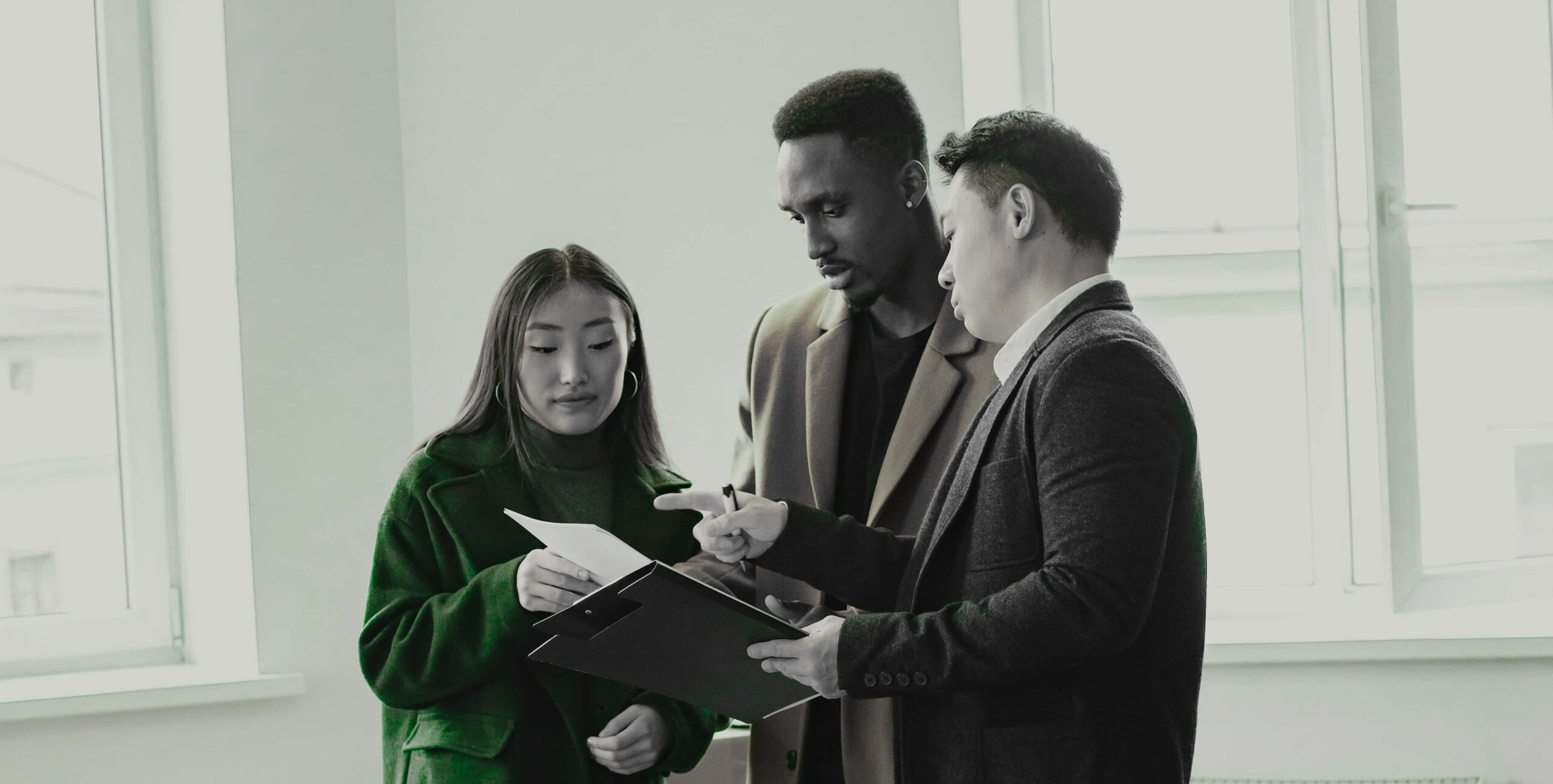 Real estate professionals reviewing a property document together