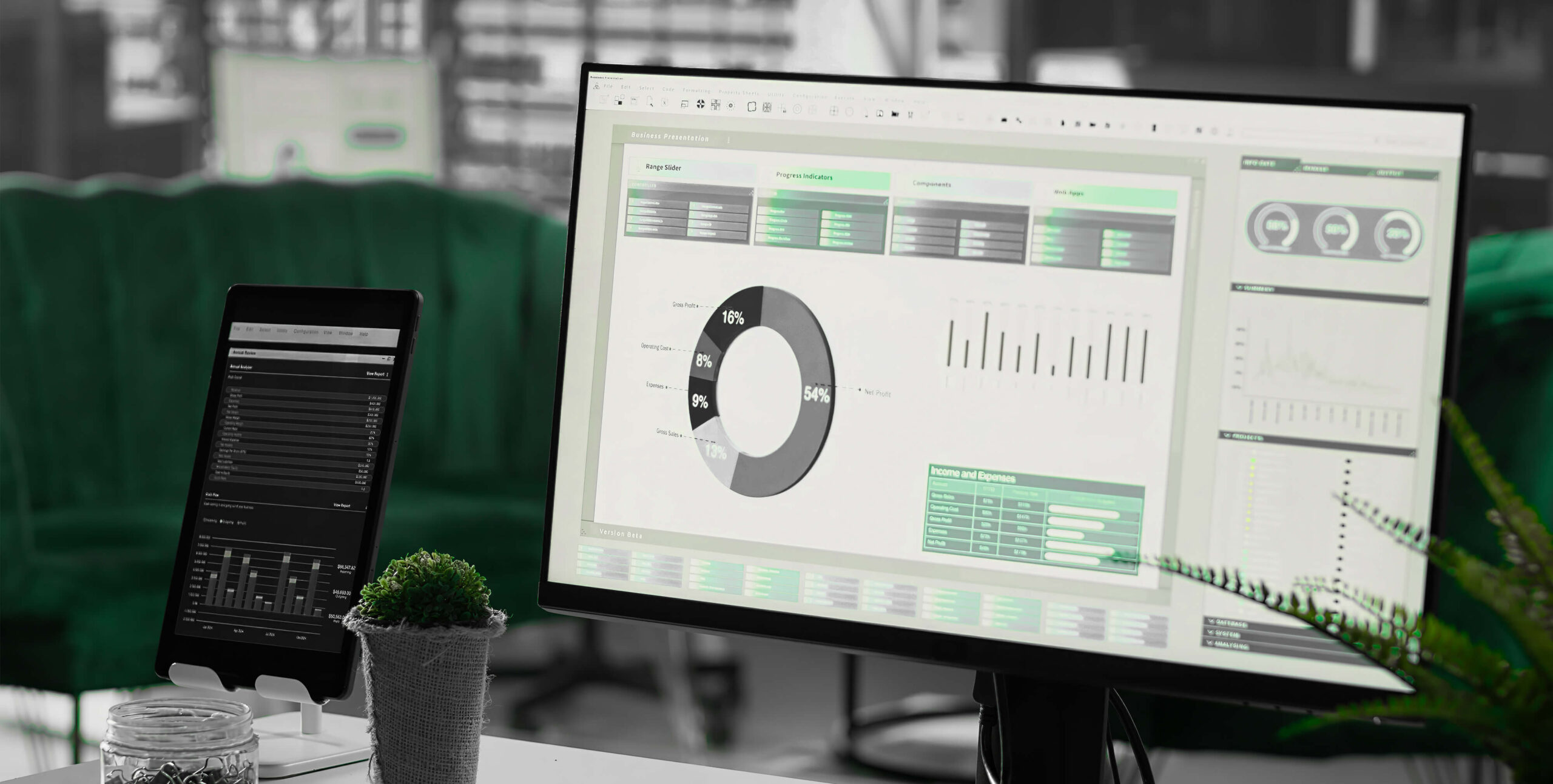 Business analytics dashboard on monitor and tablet, real estate financial reporting