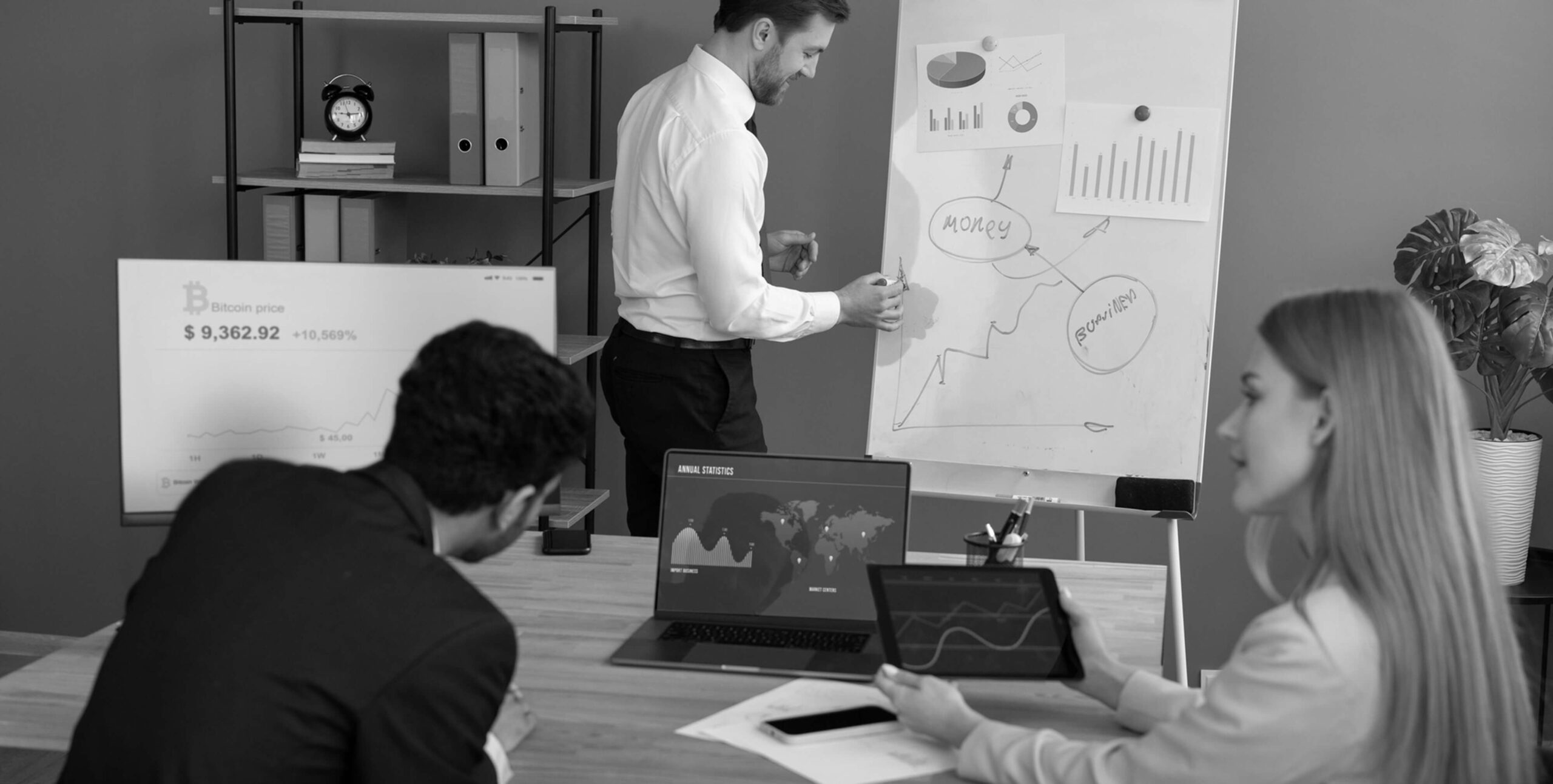 Team analyzing a financial whiteboard, real estate market analysis