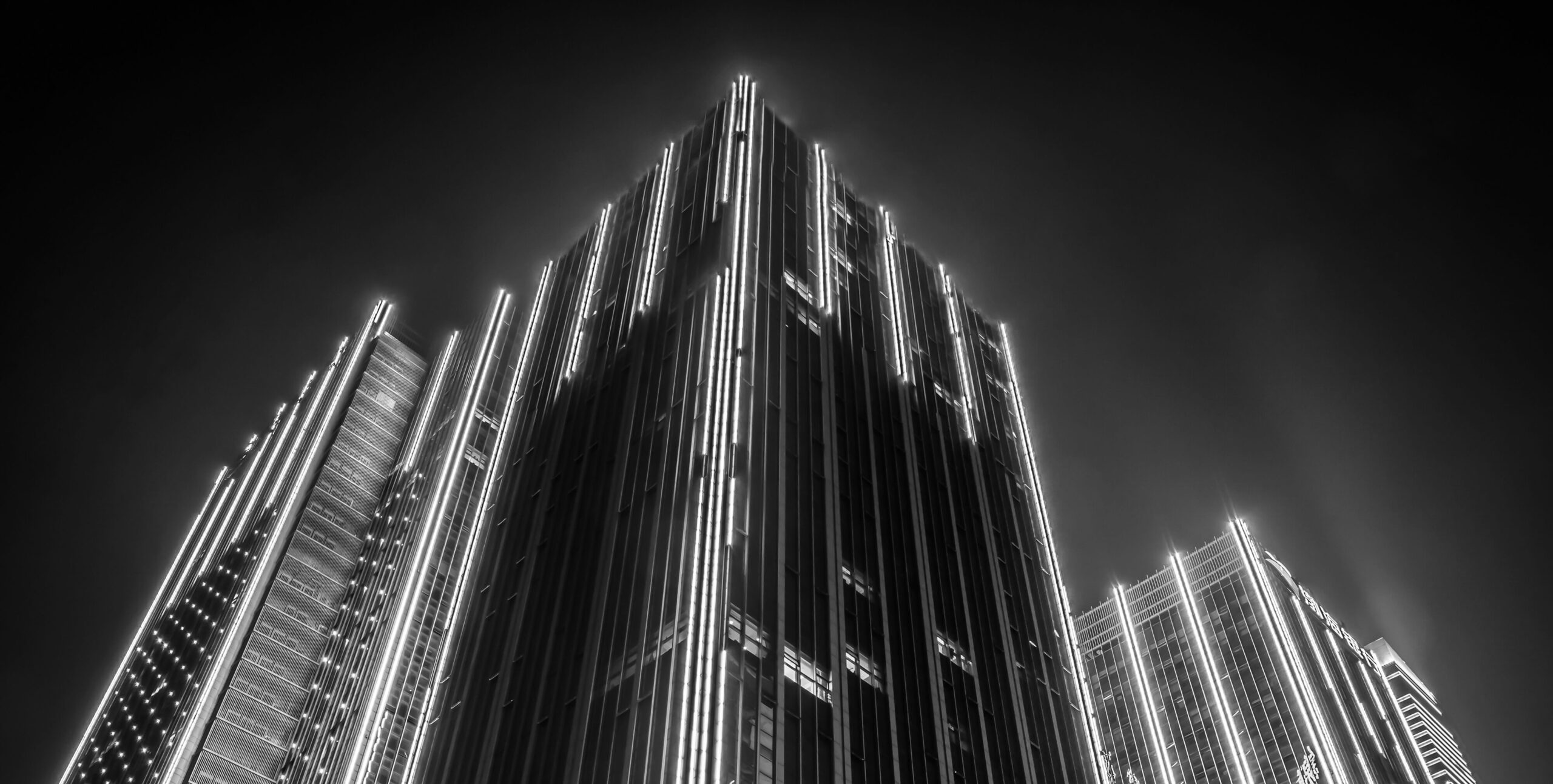 Illuminated skyscrapers at night, premium Dubai real estate architecture