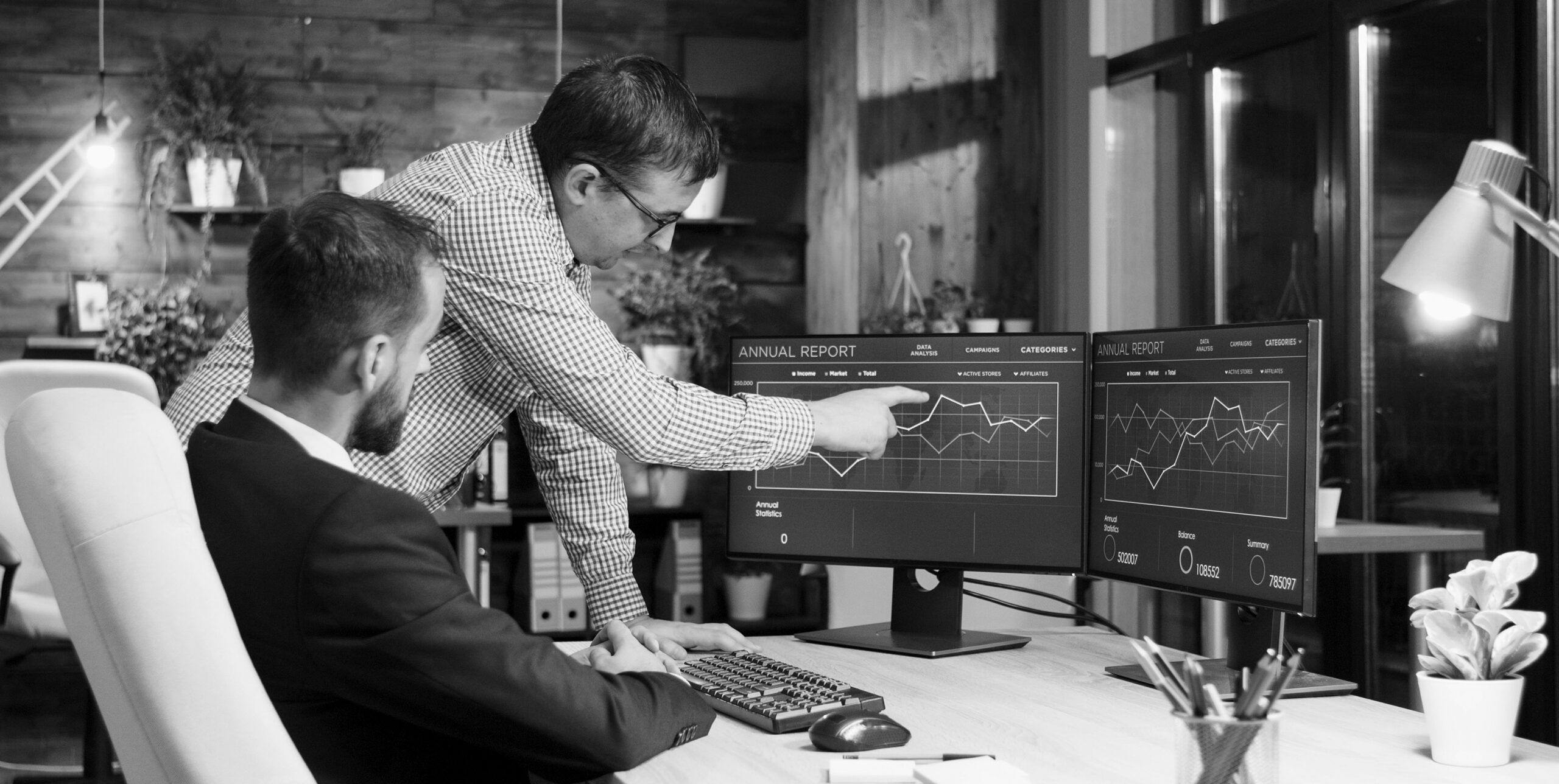 Colleagues reviewing an annual report dashboard, real estate marketing reporting