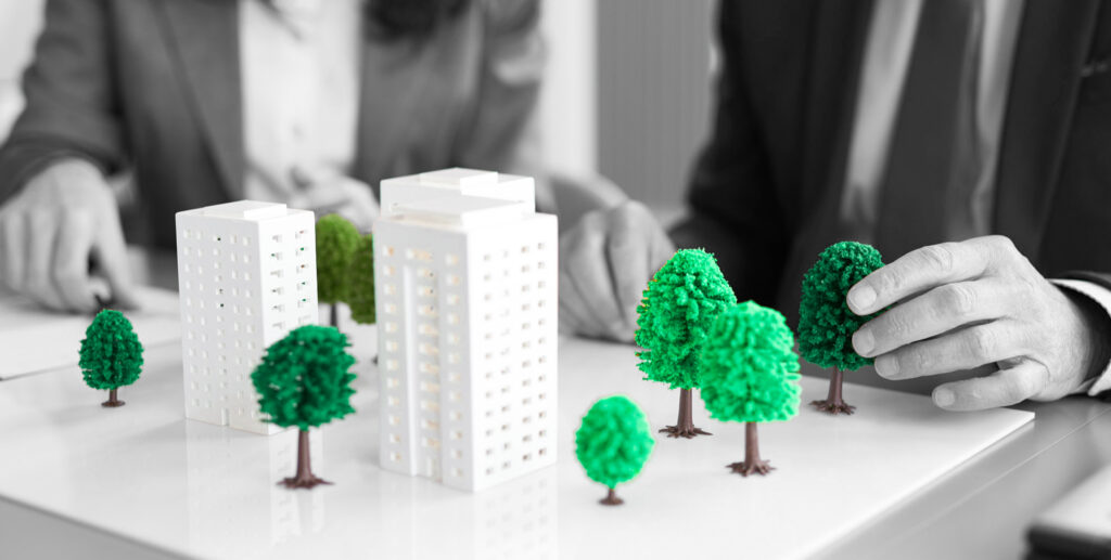 Professionals arranging building models, real estate development and urban planning