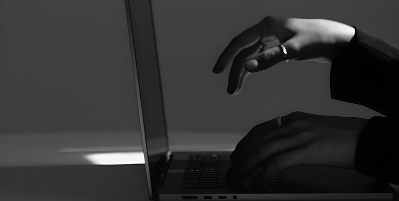 Hands on a laptop keyboard, digital real estate marketing work