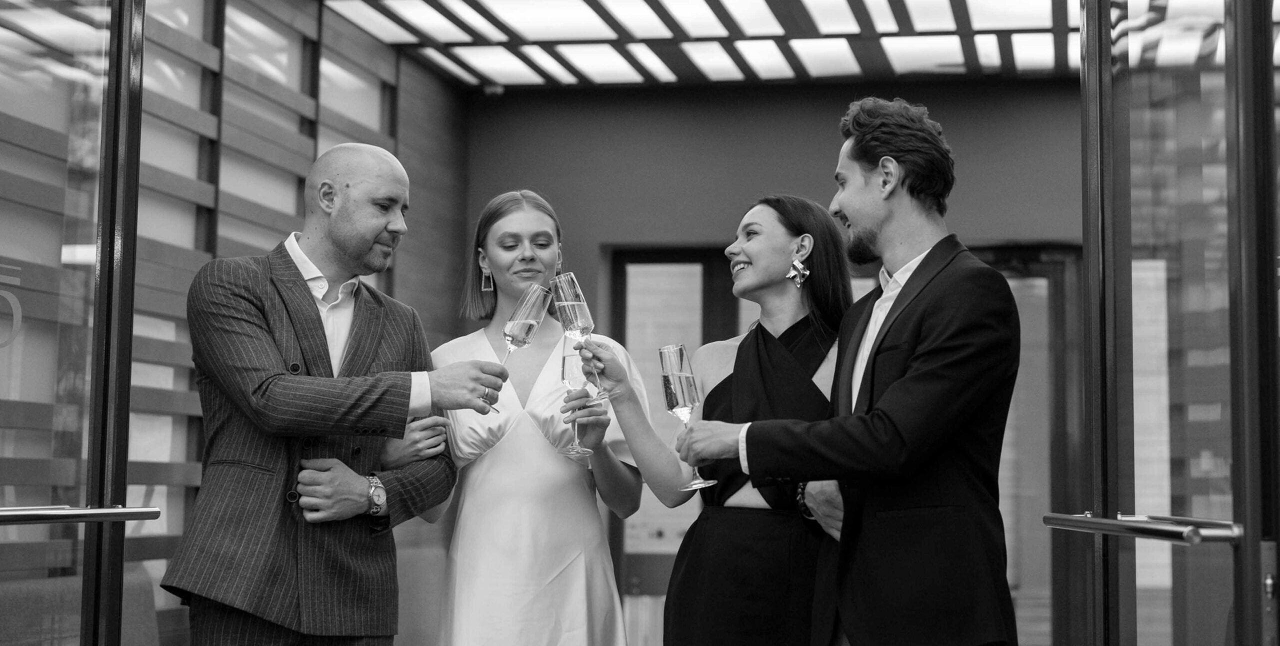 Couples toasting champagne at a property launch, luxury real estate event