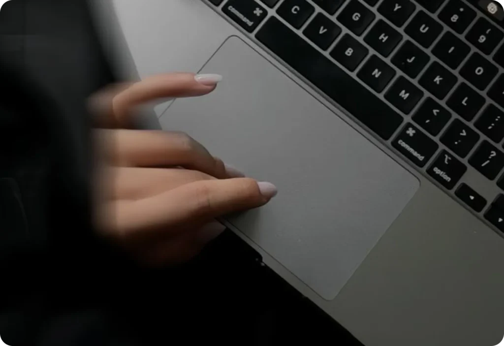 Hand using laptop trackpad closeup