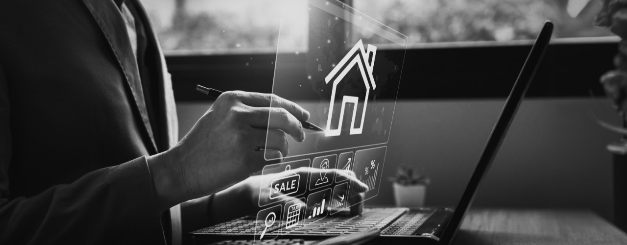 Stylus on laptop with house icon, digital real estate marketing tools