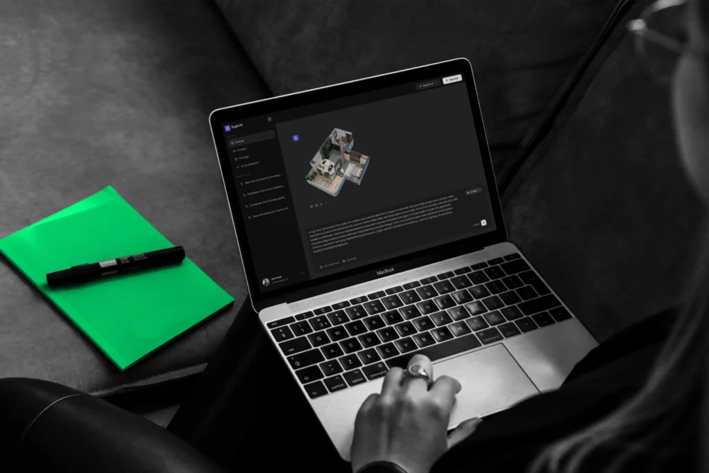 Laptop with green notebook beside